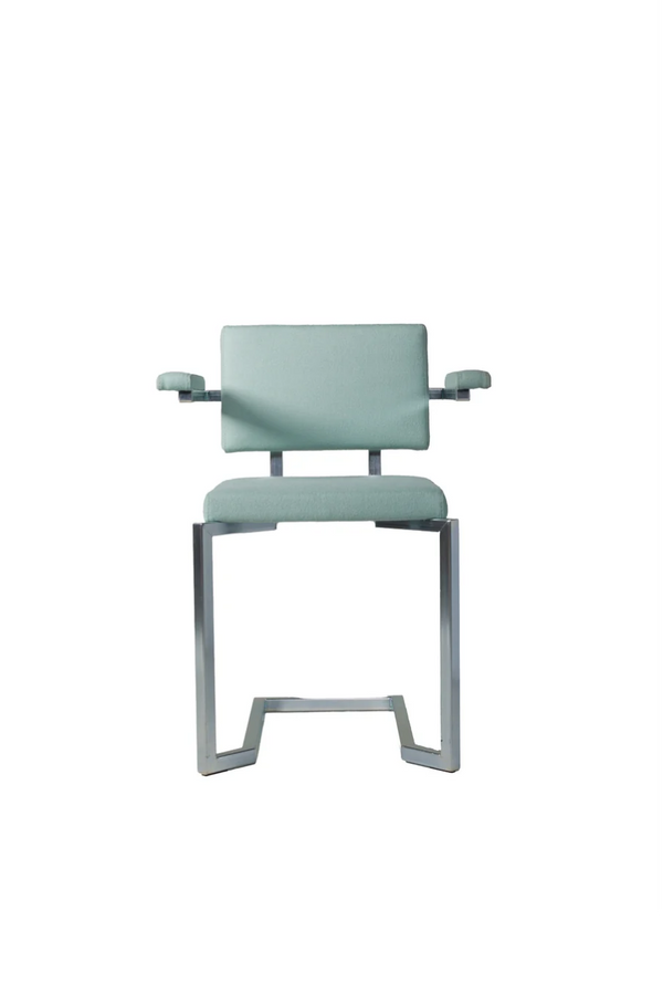 AVL Koker Chair - with armrests - grey green, pale wool upholstery seen head-on on a chrome frame