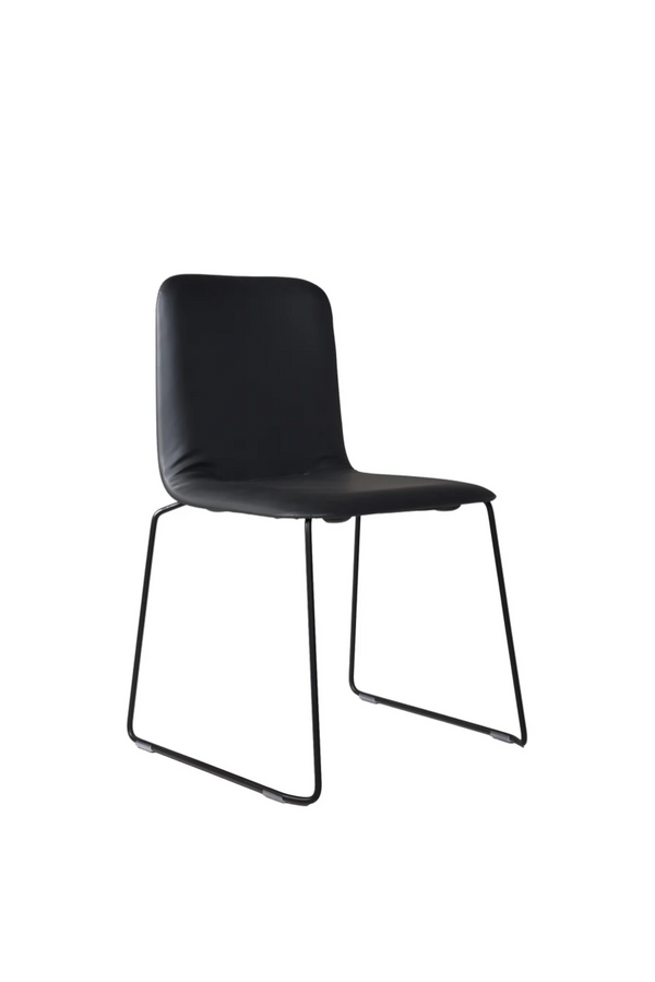 This Chair 141 PP - Stackable - Black upholstered, black leather-look seat on a black sled frame